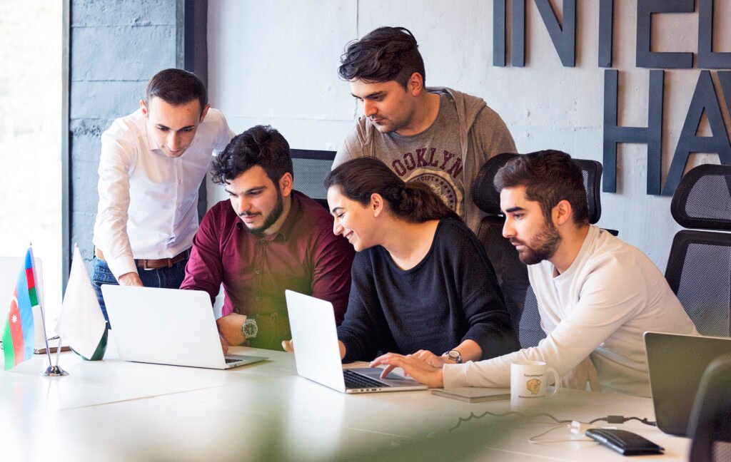 Philotech colleagues collaborating on a client IT project